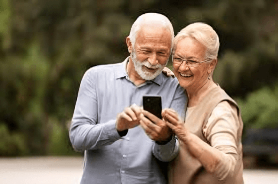 Elderly couple using smartphone together